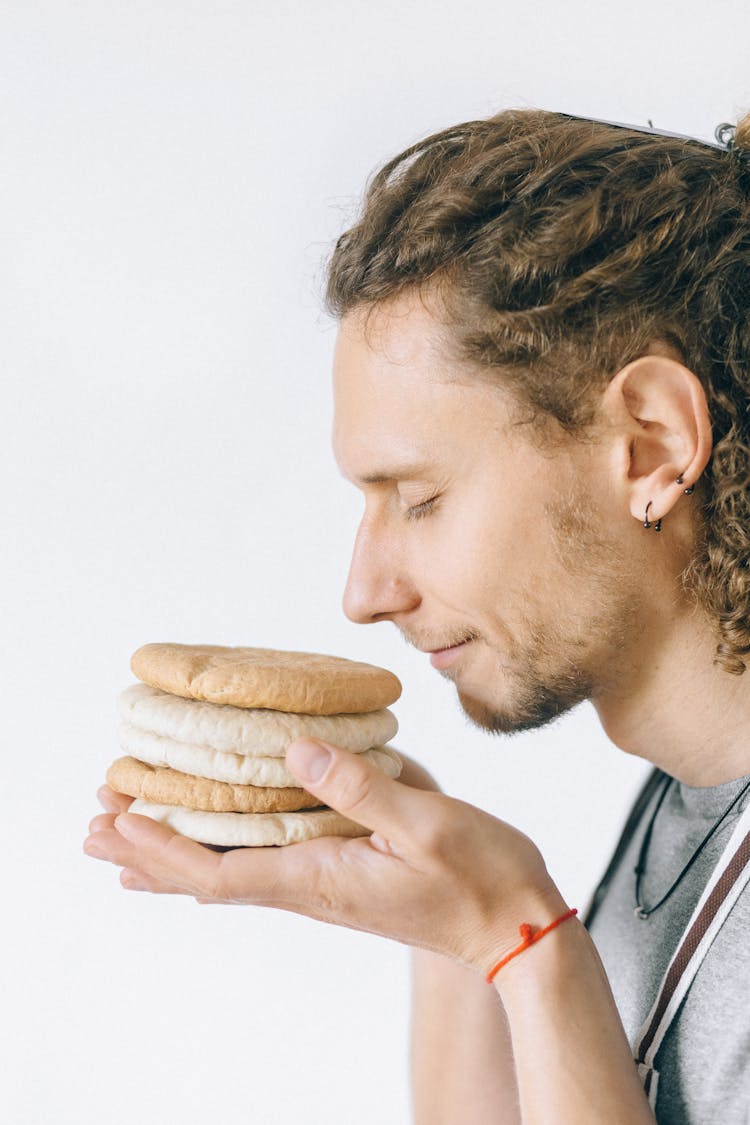 Side View Of A Man Smelling Bread