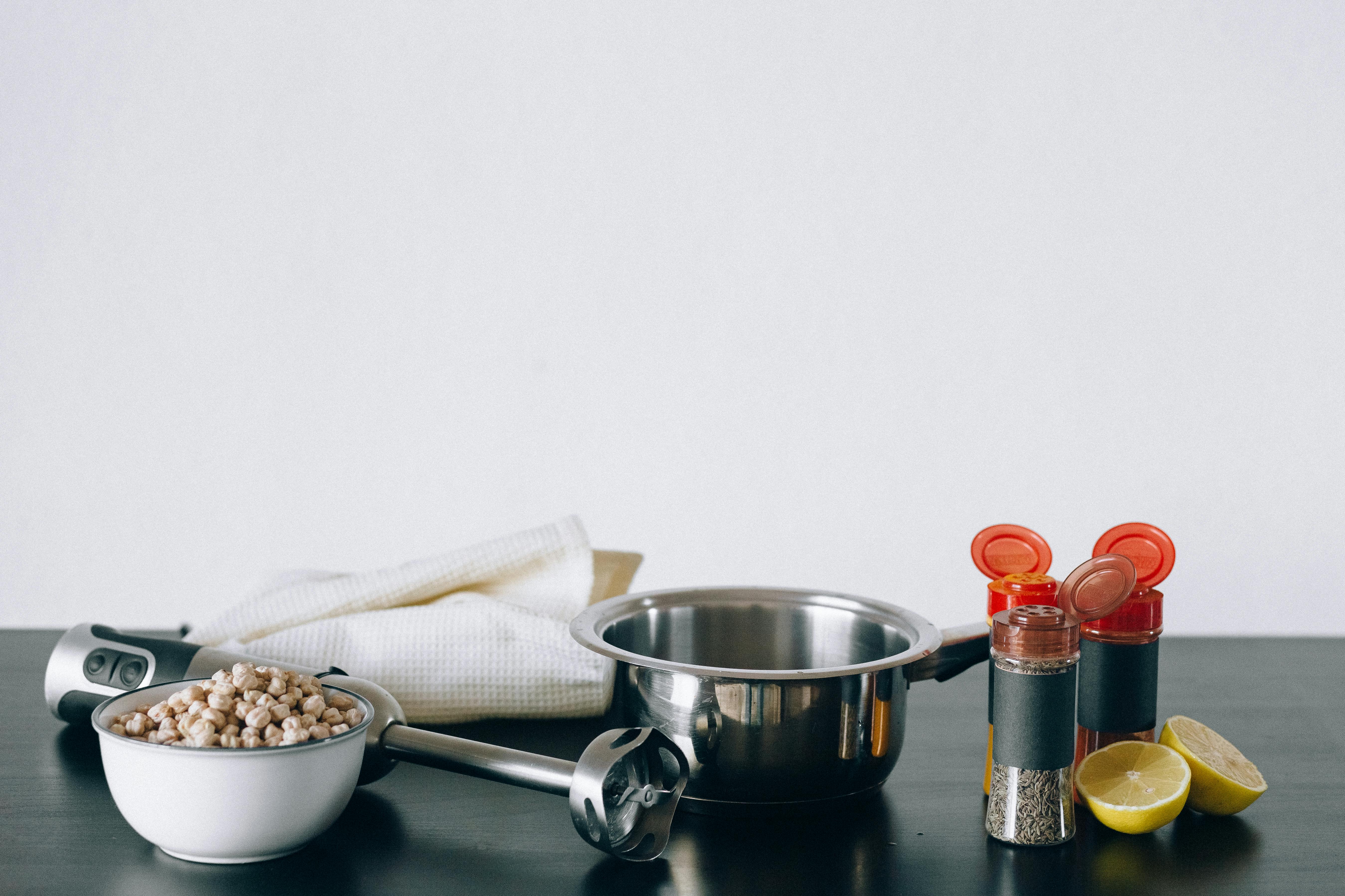 stainless steel cup beside white ceramic bowl