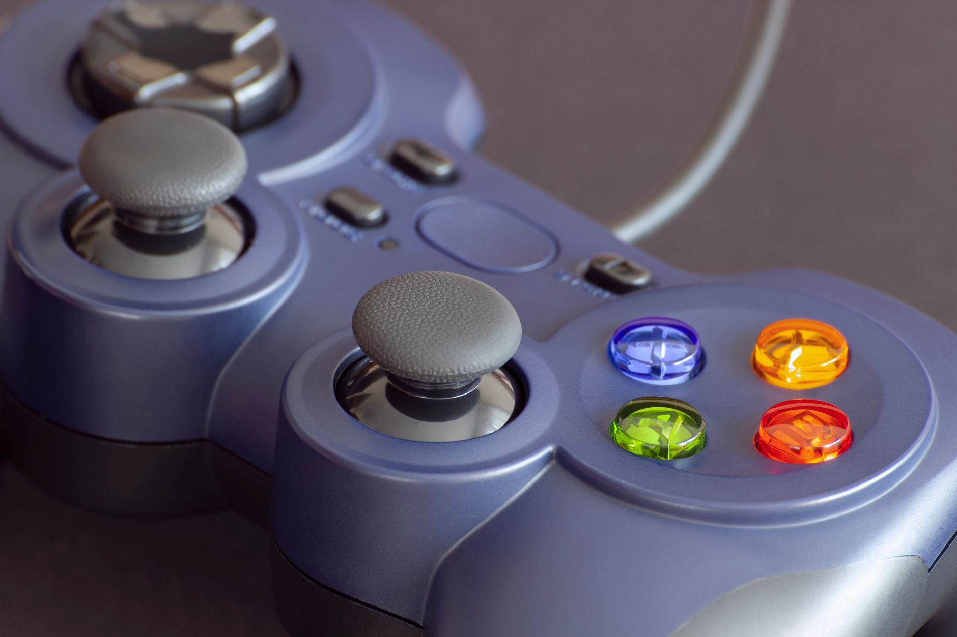 Detailed close-up of a gaming controller emphasizing its vibrant buttons.