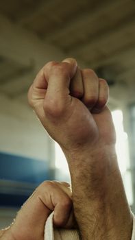 Vertical close-up of two fists raised symbolizing strength and unity.