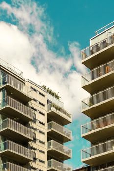 Low angle shot of modern apartment buildings with balconies in Oslo, Norway against a clear blue sky.