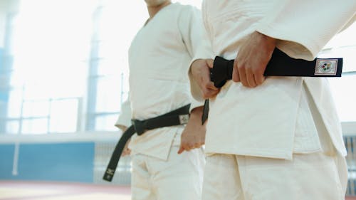Free Close-Up Shot of Two People Wearing Karategi and Black Belt Stock Photo