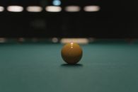 Selective Focus Photograph of a Billiard Ball on a Green Surface