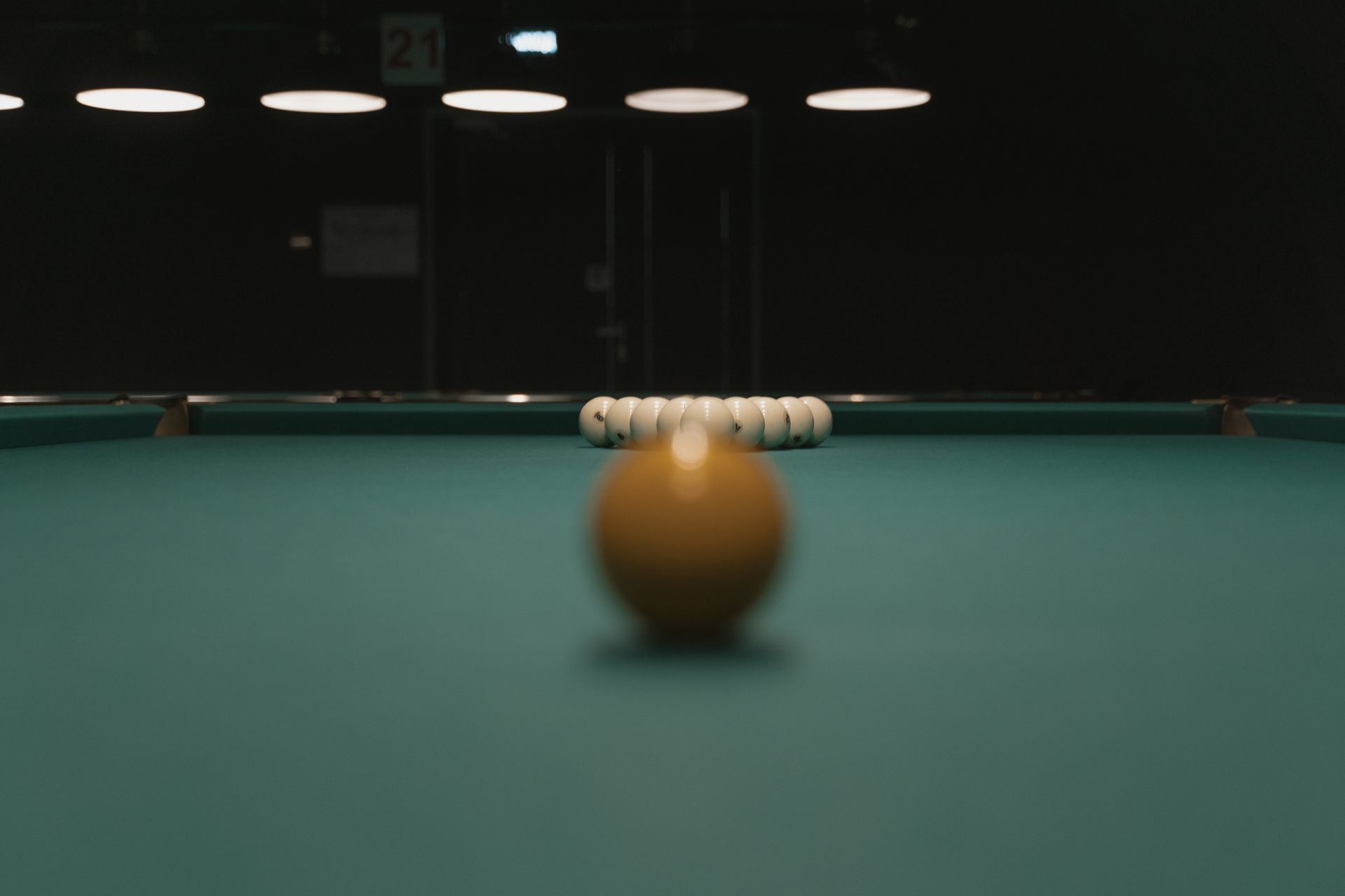 A detailed shot of a pool table with billiard balls aligned, focused view for gaming enthusiasts.