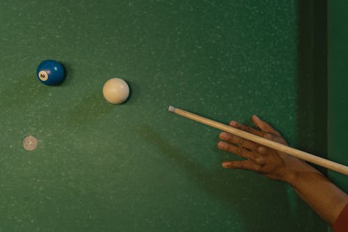 Overhead Shot of a Person's Hand Playing Billiards