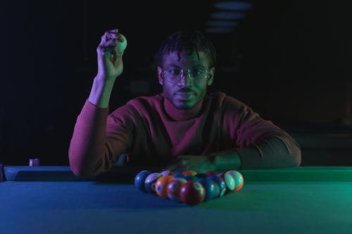 Free Photo of a Man with Eyeglasses Holding a Cue Ball Stock Photo