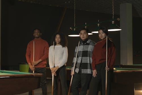 Free Photo of a Group of Friends Holding Cue Sticks Stock Photo