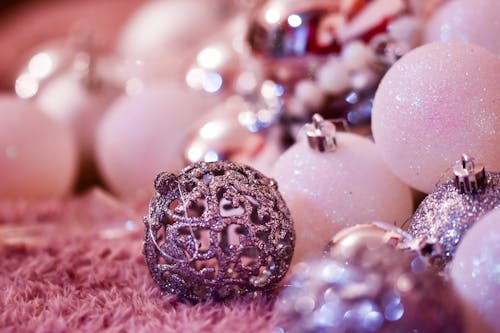 Free Abundance of various glossy baubles placed on pink carpet in light room on blurred background during festive Christmas celebration at home Stock Photo