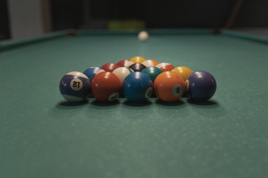 Close-up view of colorful billiard balls arranged on a pool table, perfect for sports enthusiasts.