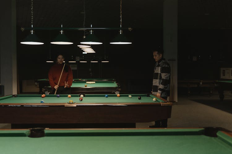 Man And Woman Playing Billiards