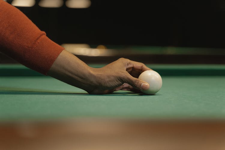 Person Holding A Cue Ball