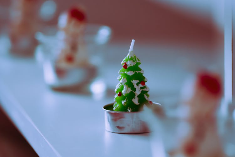 Christmas Tree Shaped Candle Placed On Shelf In Shop