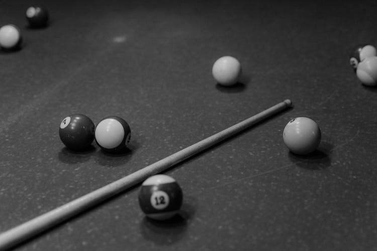 Close Up Shot Of A Cue Stick And Billiard Balls