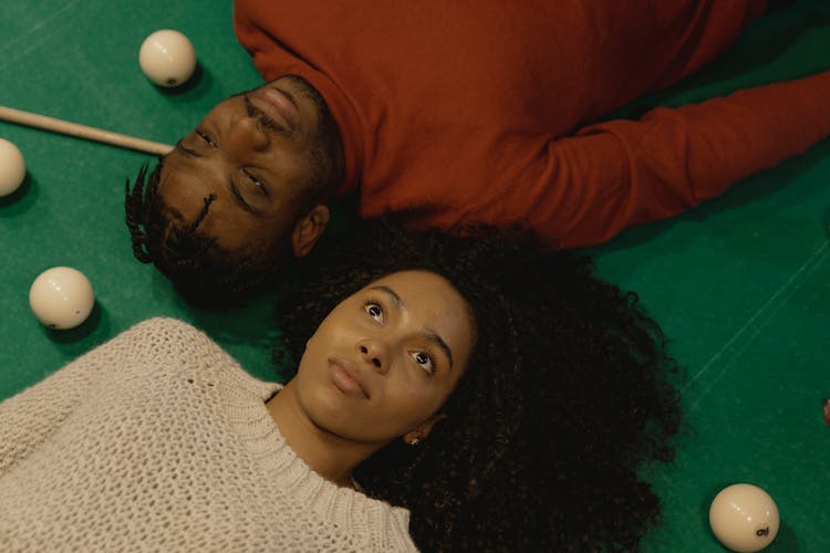 Overhead Shot Of A Couple Lying On A Pool Table