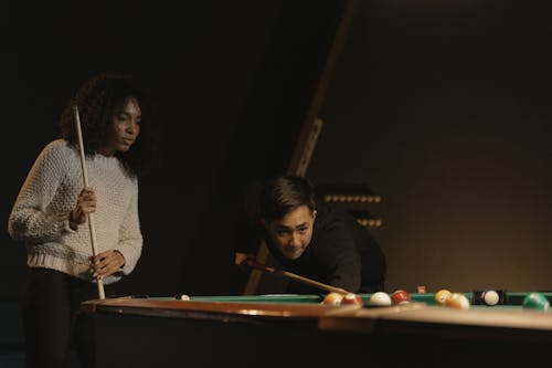 A Man and a Woman Playing Billiards