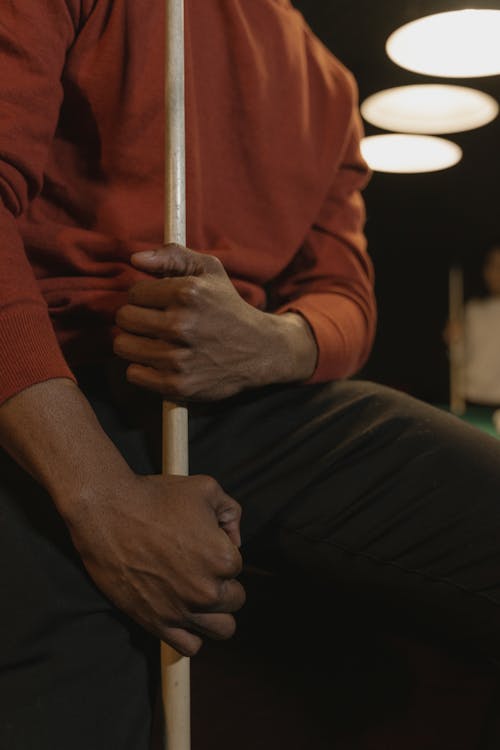 Close-Up Shot of a Person Holding a Cue Stick