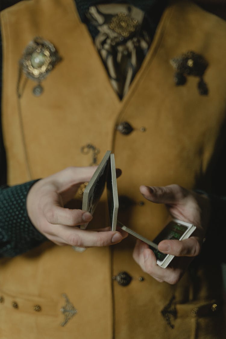 A Person Shuffling A Deck Of Cards