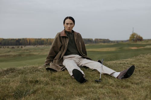A Golfer Sitting on the Grass