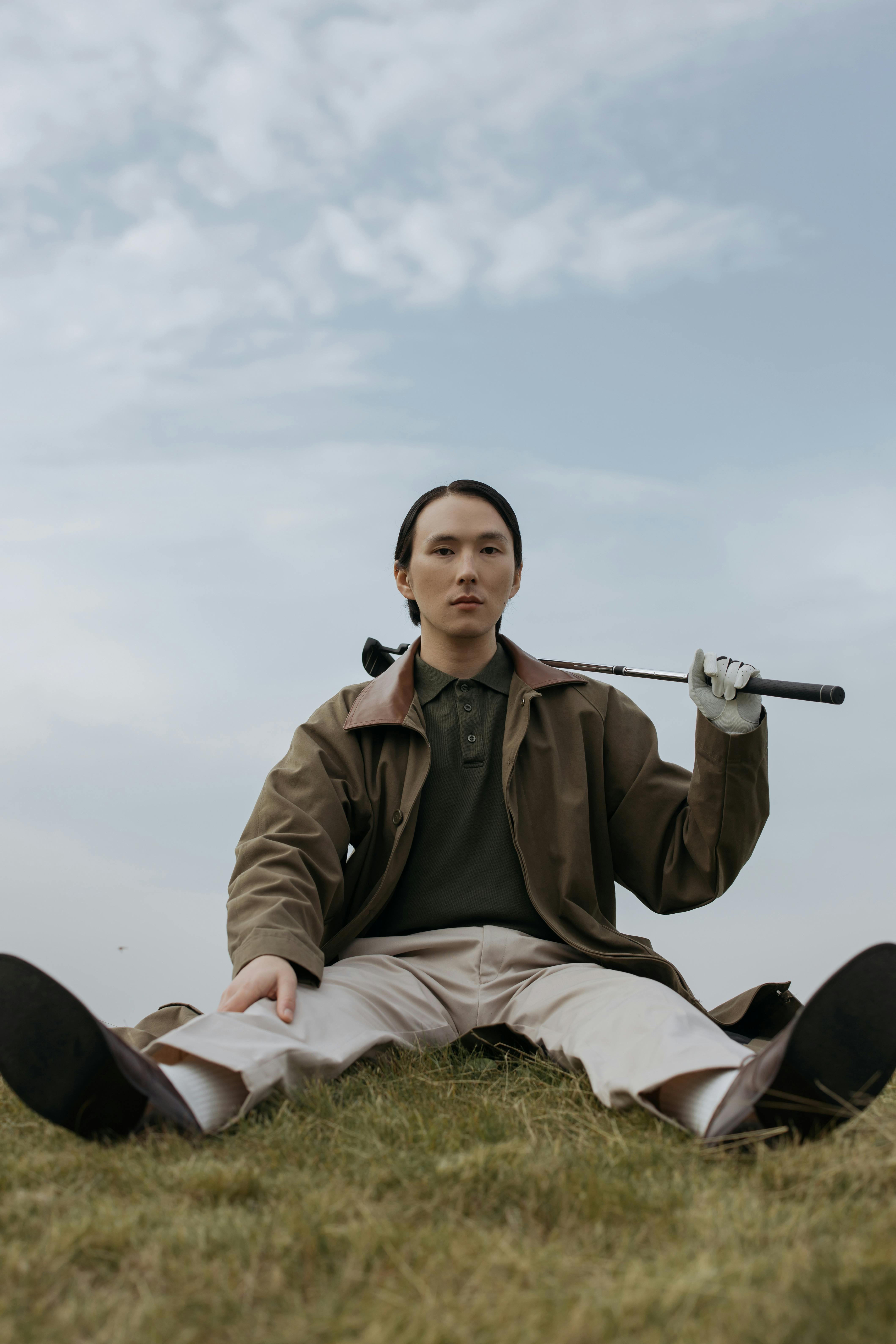 a golfer sitting on the grass