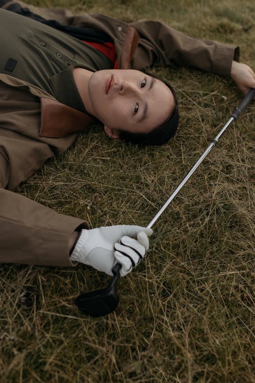 Free A Golfer Lying on the Grass Stock Photo