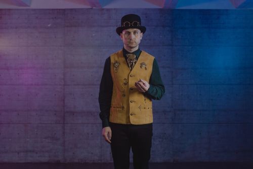 Free Magician in steampunk attire performing indoors with dramatic lighting. Stock Photo