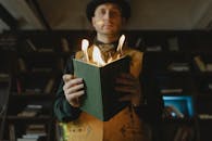 A Man Holding a Book with Fire