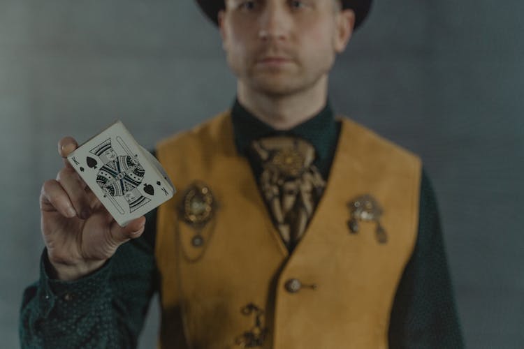 Close Up Shot Of A Man Holding A Card 