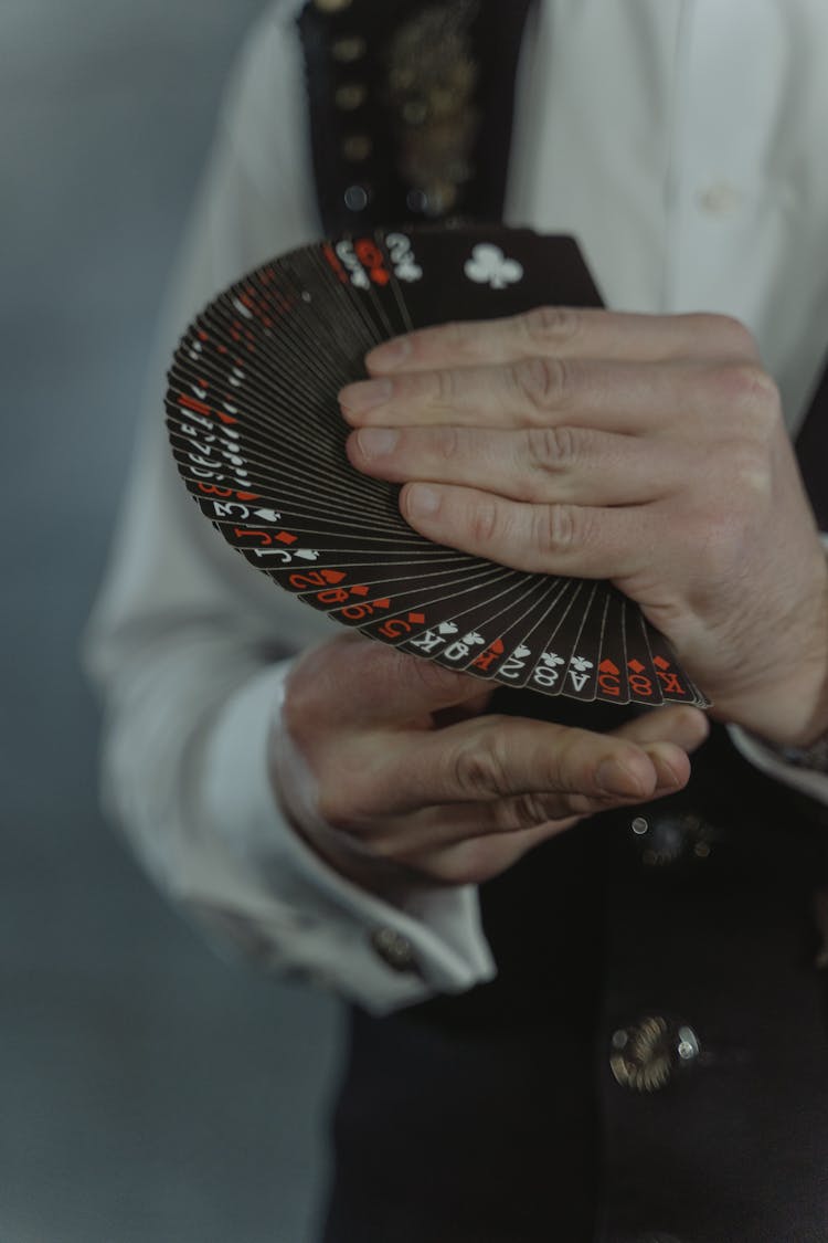 Man In White Shirt Holding Black Cards Fan