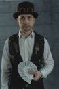 A Man Standing while Holding Cards