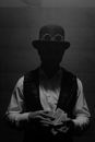 Grayscale Photo of a Man Doing a Magic Trick