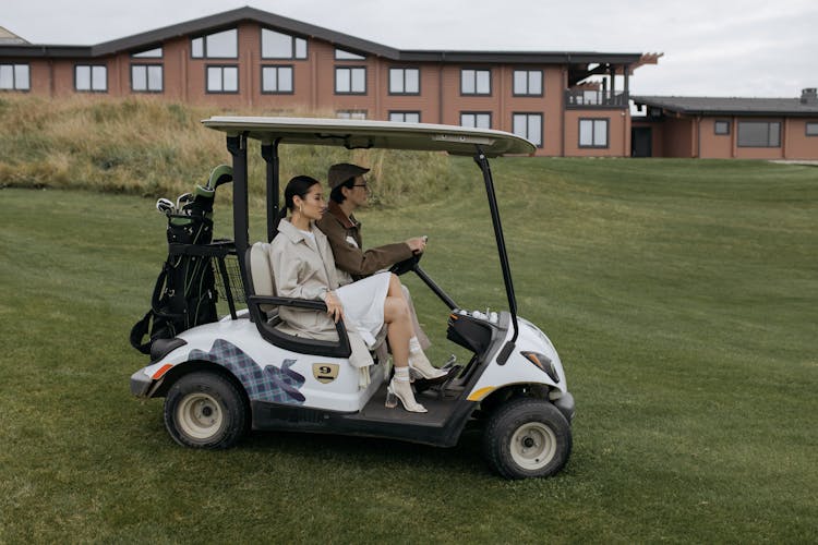 Man And Woman In The Golf Cart 