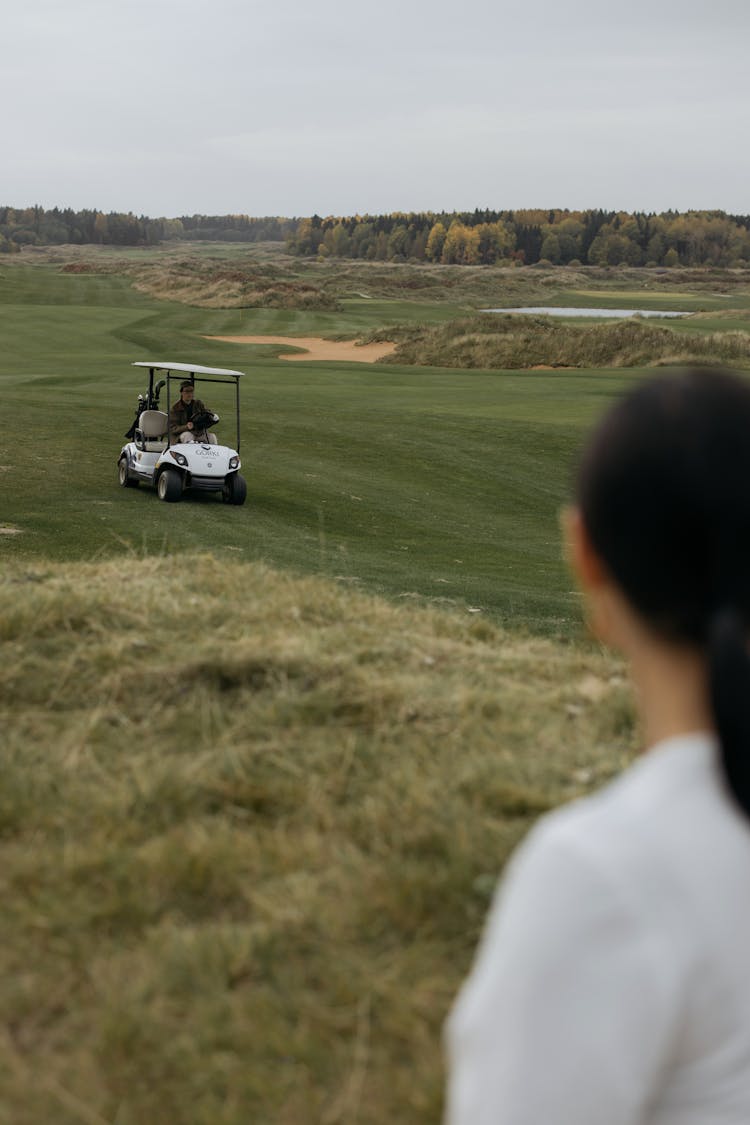 Man Driving Golf Cart In The Golf Course