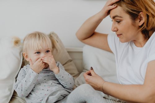 Free A mother and her child share a tender moment on a couch. Emotion and connection are evident. Stock Photo