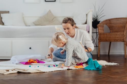 Free A mother and daughter enjoy crafting in a cozy indoor setting, fostering creativity and bonding. Stock Photo
