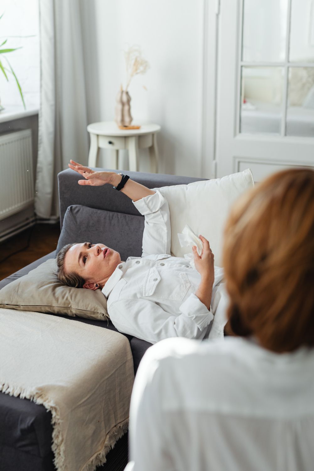 Woman in White Long Sleeves Lying on Sofa · Free Stock Photo