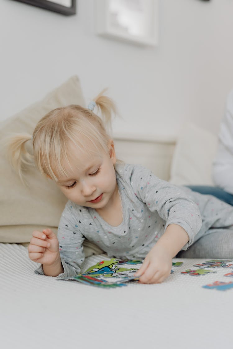 Blond Girl Playing With Puzzles