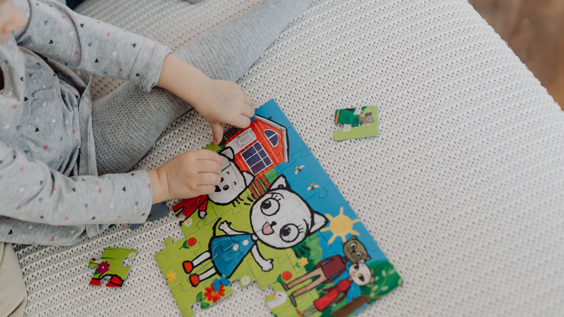Is Modafinil a Stimulant? Unlocking the Truth A child assembling a colorful cartoon puzzle indoors, capturing playtime creativity.