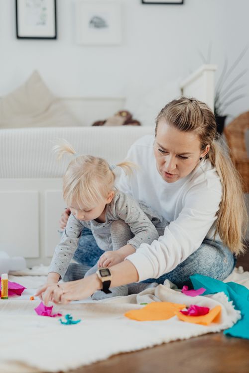 Free A mother and young daughter engage in creative play together at their cozy home. Stock Photo