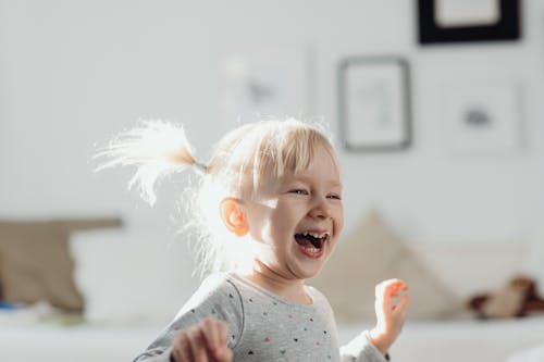 Shallow Focus Photo of Cute Girl Laughing