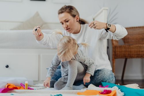 Free Mother and child bonding over arts and crafts indoors. Engaged in creative activity with colorful materials. Stock Photo