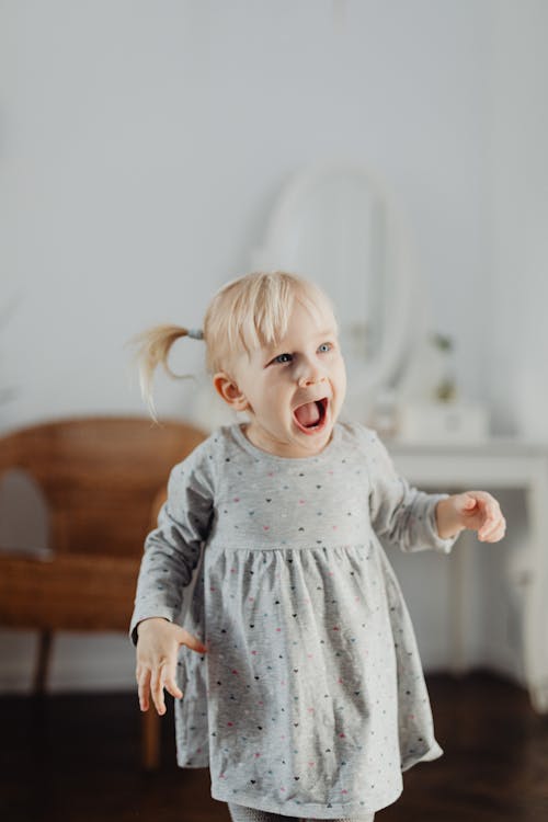 Free Shallow Focus Photo of Cute Girl in Gray Dress Stock Photo