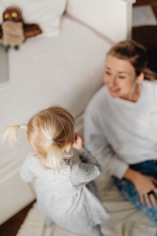 Free A warm scene of a mother and toddler enjoying playful moments together indoors. Stock Photo