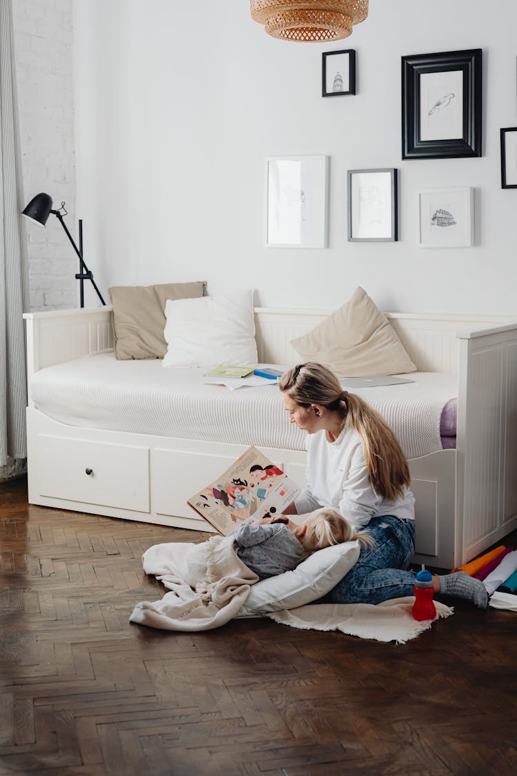 Mother Reading Book With Daughter