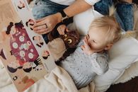 A Girl Lying Down While Reading a Storybook