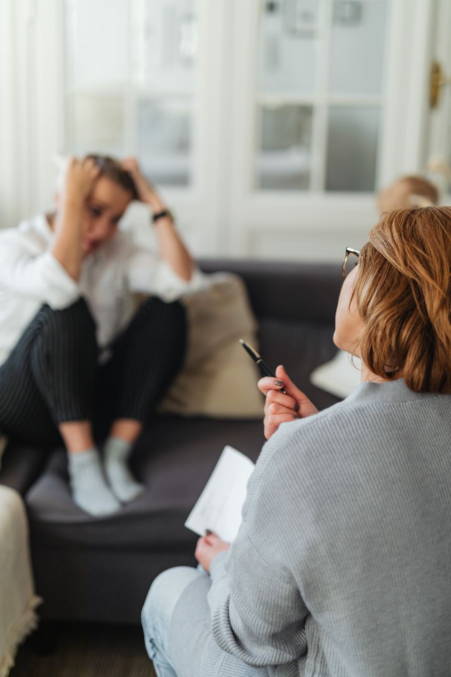 Counselor supporting a client with anxiety and emotional distress
