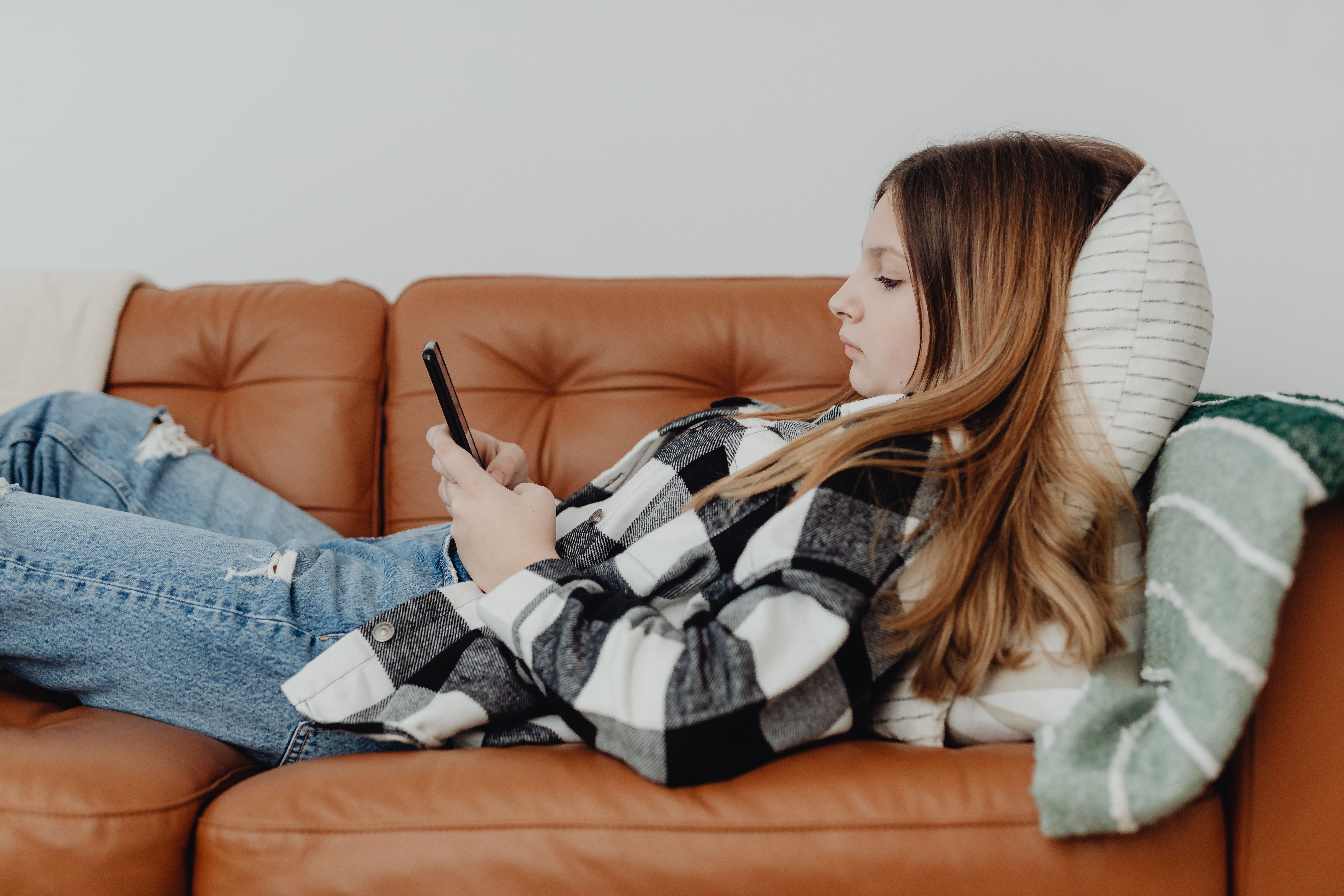 Young person using smartphone in dimly lit environment