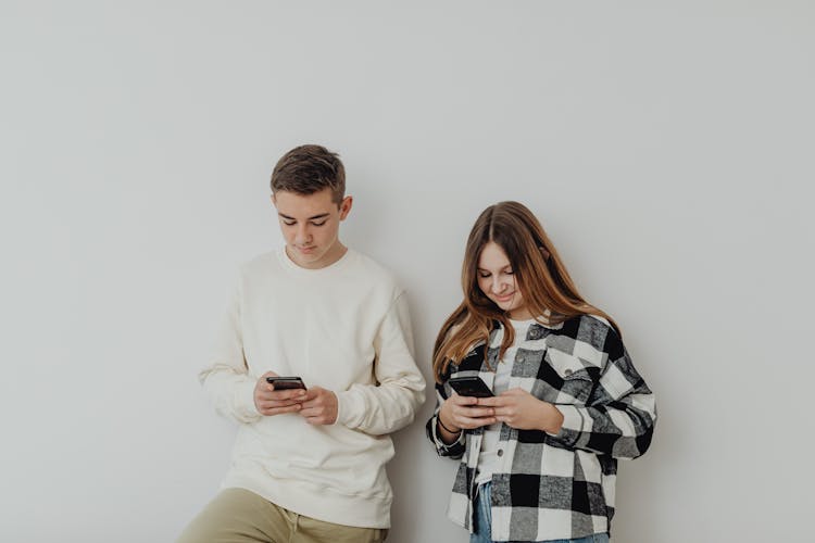 Young Couple Using Smartphones