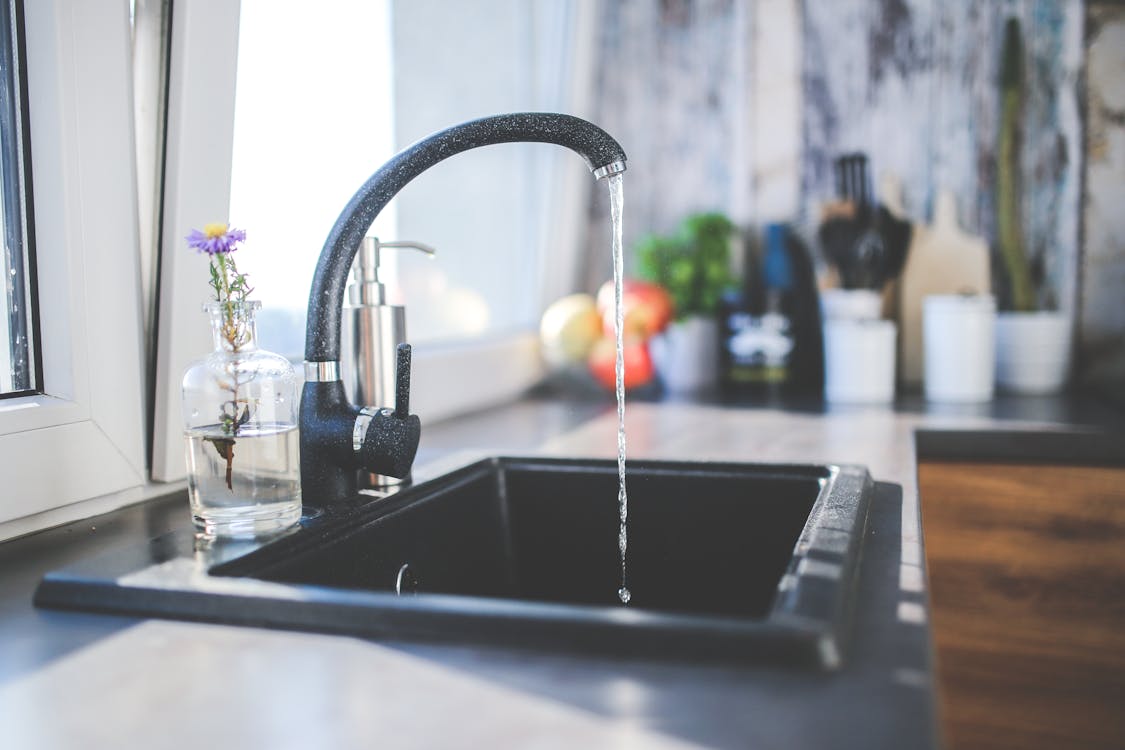 Free Water flows from the tap to sink Stock Photo
