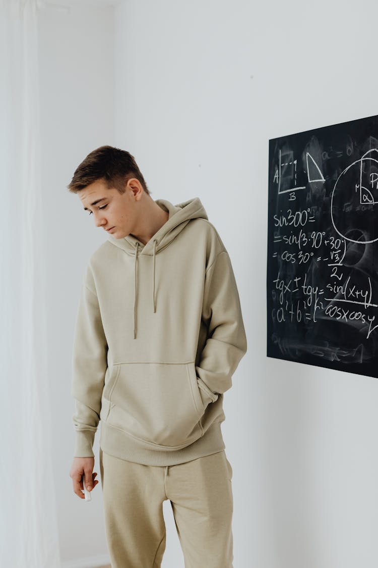 Boy In Beige Hoodie Looking Disappointed