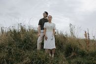 Man and Woman Standing on Green Grass Field